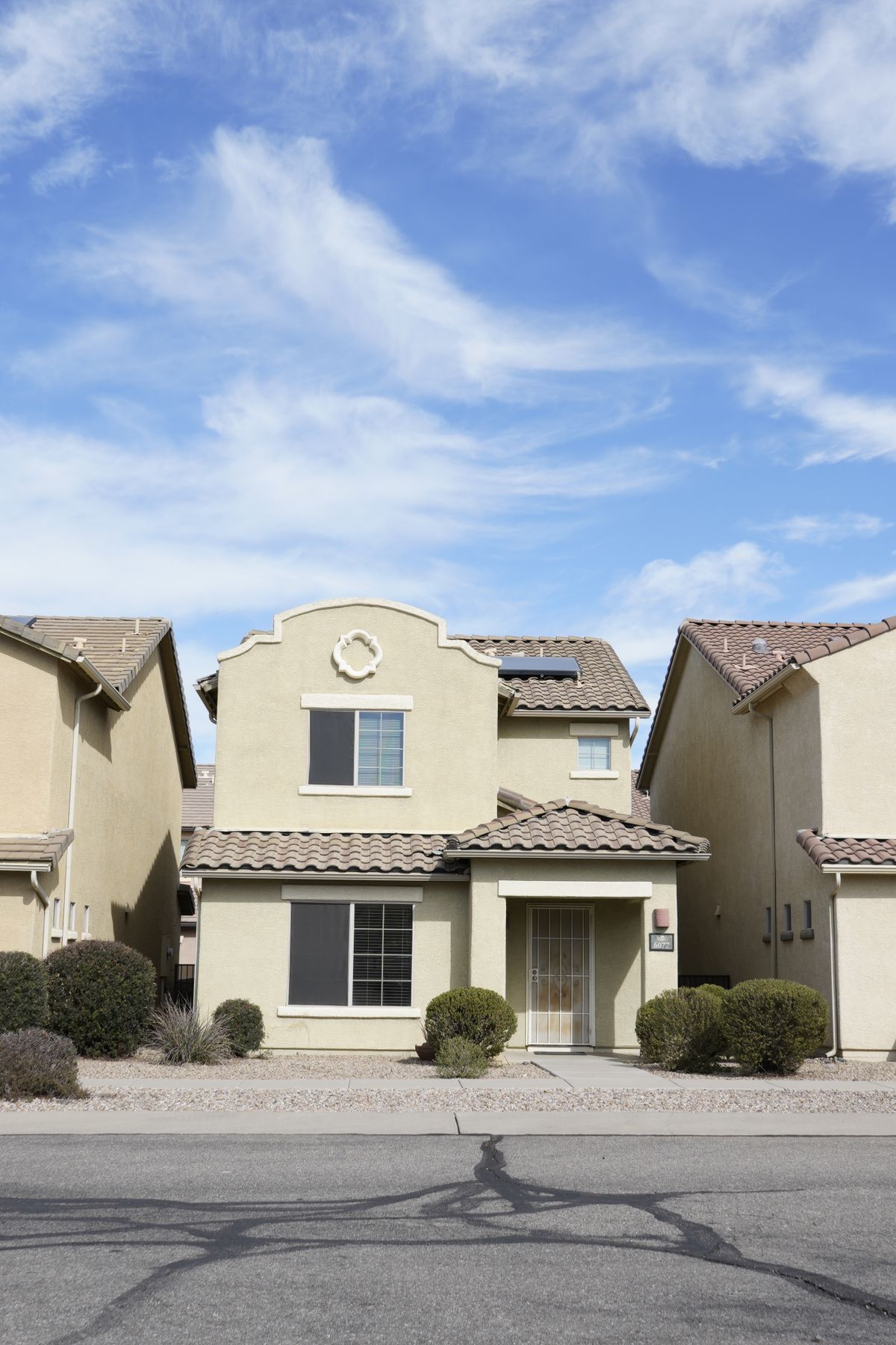 Stucco home with a tile roof under a bright Central Valley sky
